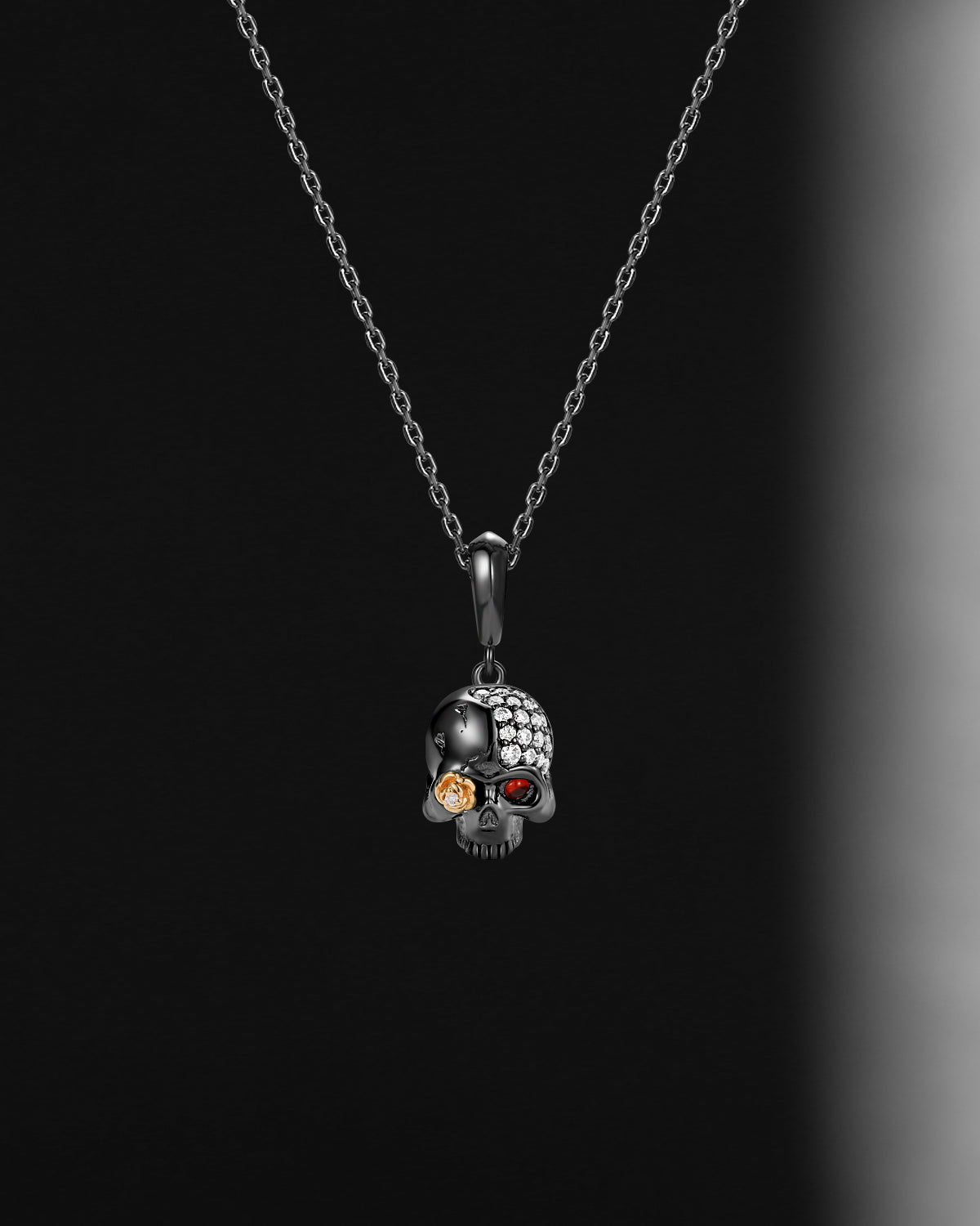 Skull-shaped pendant necklace with embedded stones on a dark background