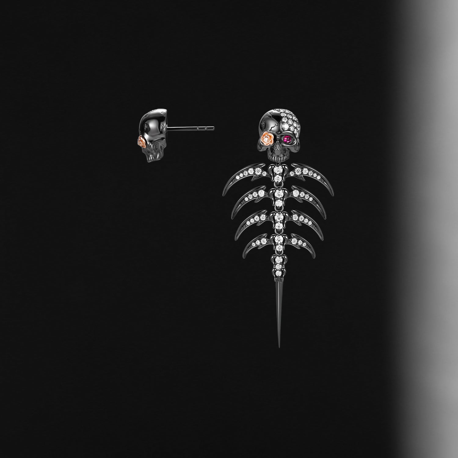 Skull-shaped earring with clear stones on a black background