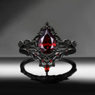 'Bat's Whisper' - Gothic Pear Cut Garnet Alternative Bridal Engagement Ring Set with Bat Wings in Black Gold