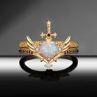 Heart & Sword - Gothic Cabochon Heart Cut Lab Opal Two-Tone Bridal Set with Angel Wing-inspired Band