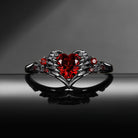 Heart & Sword 'Pierced Heart' – Gothic Garnet Engagement Ring with Angel Wing Detail