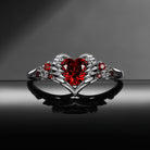 Heart & Sword 'Pierced Heart' – Gothic Garnet Engagement Ring with Angel Wing Detail