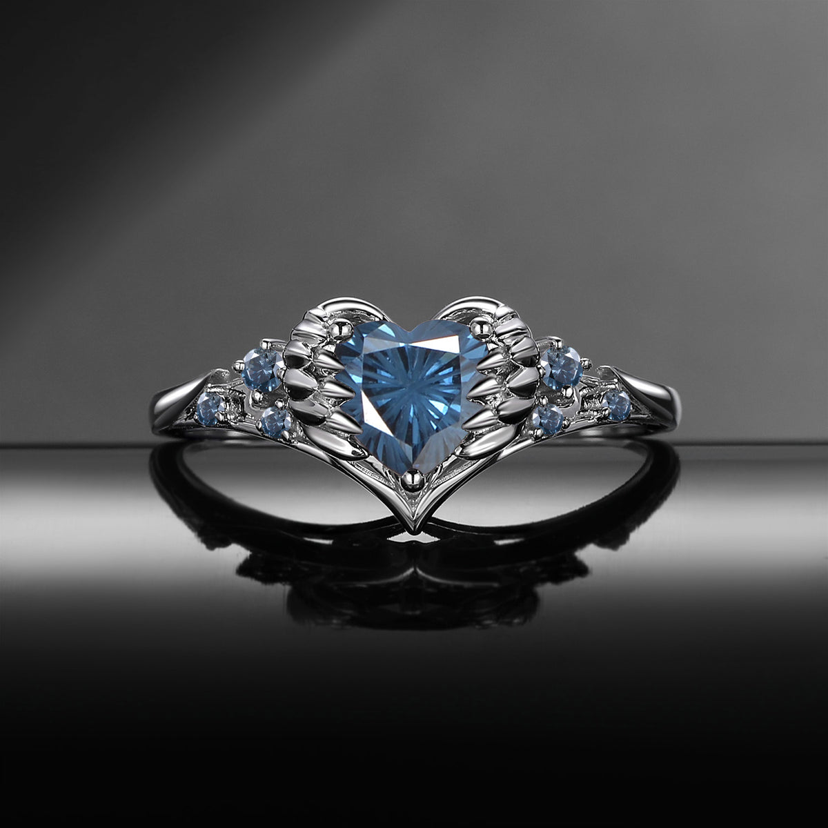 'Pierced Heart' – Gothic Firework Cut Blue Moissanite Heart & Sword Engagement Ring with Angel Wing Detail