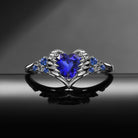 'Pierced Heart' – Gothic Lab Sapphire Heart & Sword Engagement Ring with Angel Wing Detail
