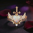 Heart & Sword - Gothic Cabochon Heart Cut Lab Opal Two-Tone Bridal Set with Angel Wing-inspired Band