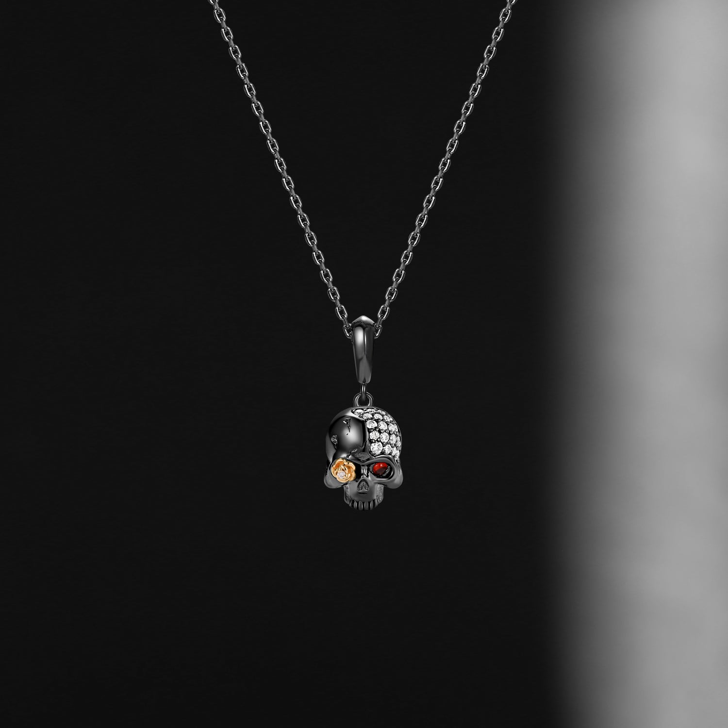 Skull-shaped pendant necklace with embedded stones on a dark background